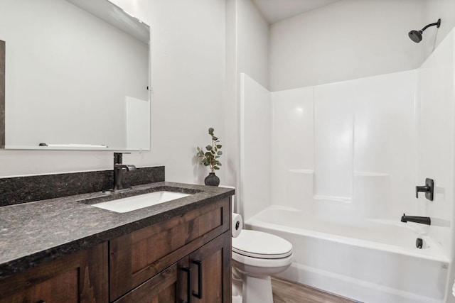 full bath featuring vanity, shower / bathing tub combination, toilet, and wood finished floors