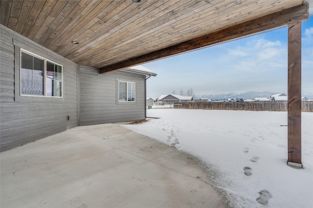 snow covered patio with fence