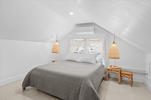 bedroom with an AC wall unit, baseboards, and vaulted ceiling