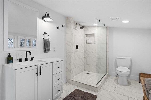 bathroom with toilet, marble finish floor, a stall shower, baseboards, and vanity