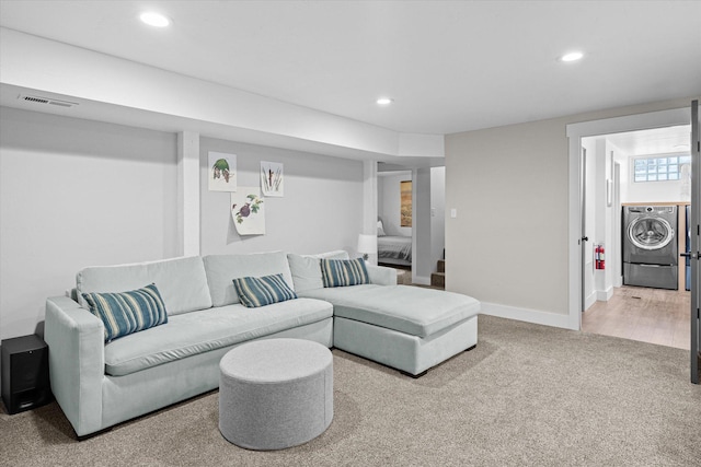 carpeted living area with visible vents, baseboards, washing machine and clothes dryer, recessed lighting, and stairs