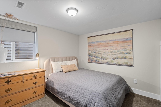 carpeted bedroom featuring visible vents and baseboards