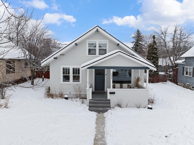 bungalow-style house with fence