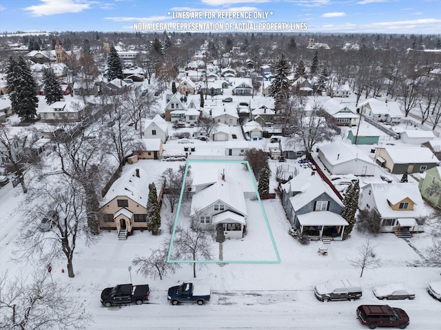 snowy aerial view with a residential view