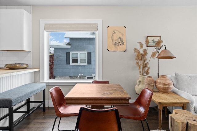 dining room with baseboards and dark wood-style flooring