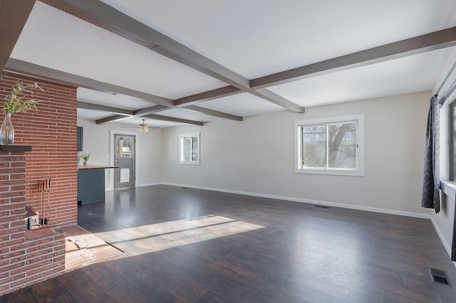 unfurnished living room with dark wood-type flooring, beam ceiling, ceiling fan, and coffered ceiling