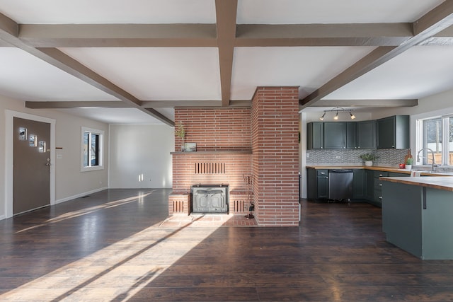 unfurnished living room with sink, beam ceiling, and dark hardwood / wood-style floors