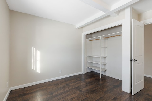 unfurnished bedroom with dark wood-type flooring