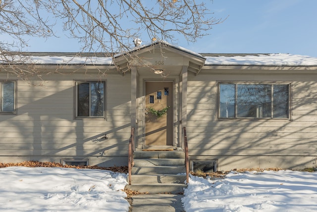 view of snow covered property entrance