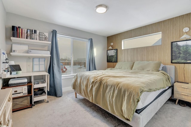 carpeted bedroom with wooden walls