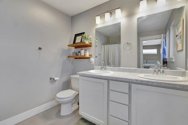 bathroom featuring toilet, a shower with shower curtain, and vanity