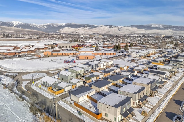 snowy aerial view featuring a mountain view