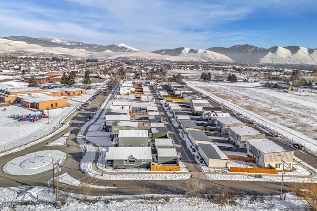 snowy aerial view featuring a mountain view