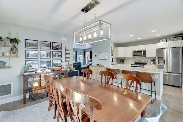 dining area featuring light wood-type flooring