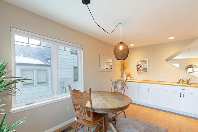 dining room with a wealth of natural light and light hardwood / wood-style flooring