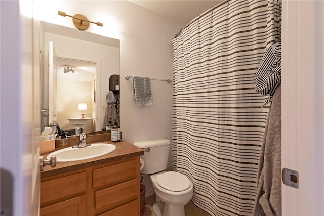 bathroom featuring toilet, vanity, and a shower with curtain