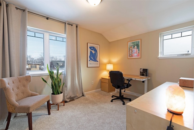 office area featuring vaulted ceiling and light colored carpet