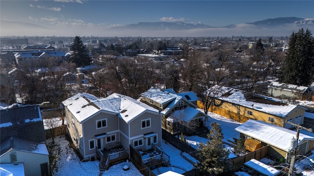 snowy aerial view featuring a mountain view