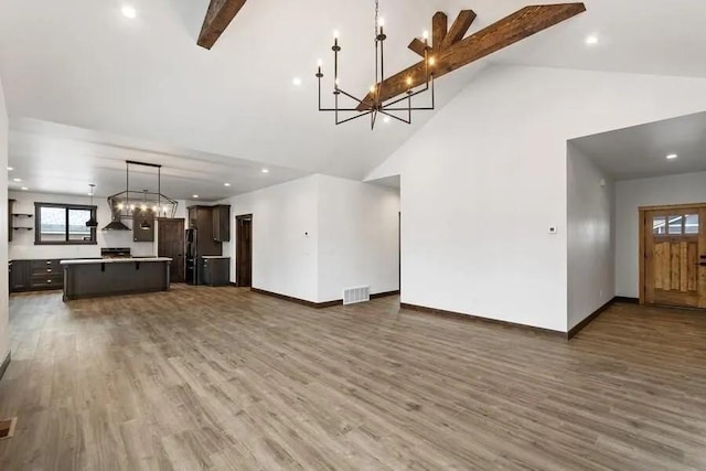 unfurnished living room featuring high vaulted ceiling, dark hardwood / wood-style floors, and beam ceiling