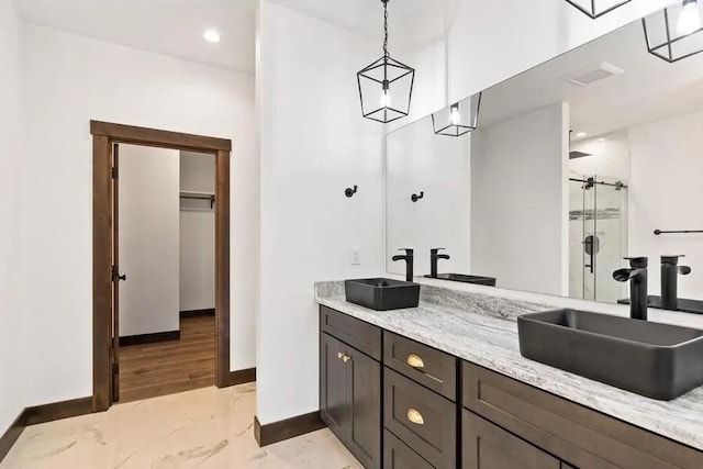 bathroom with vanity and a shower with shower door