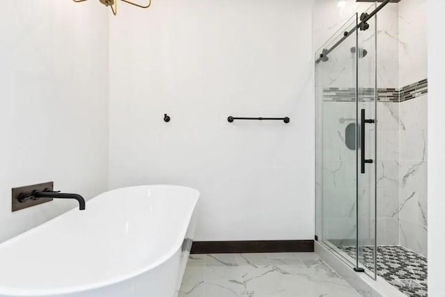 bathroom featuring shower with separate bathtub