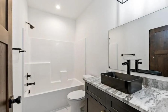 full bathroom with vanity, toilet, and  shower combination