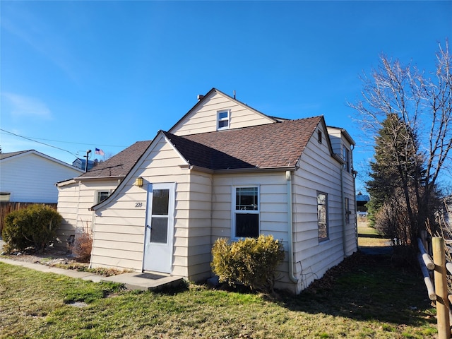 back of property with a lawn