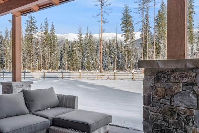 yard layered in snow with a mountain view