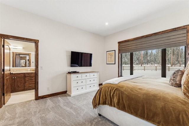 190 Black Bear Ln, Bigfork, MT 59911 - bedroom with light carpet, baseboards, and connected bathroom