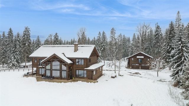 view of snow covered rear of property