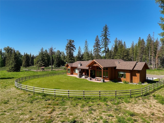190 Black Bear Ln, Bigfork, MT 59911 - back of house with a patio area, an outdoor living space, and a forest view