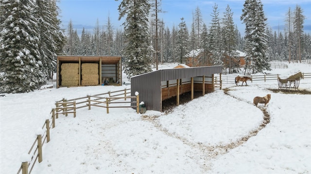 snow covered house with an outdoor structure