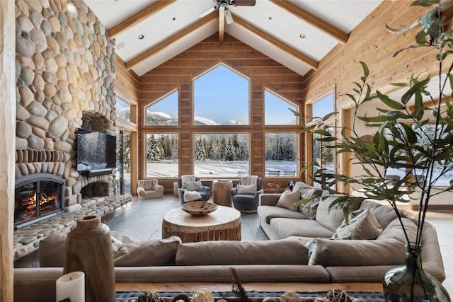 190 Black Bear Ln, Bigfork, MT 59911 - living room with high vaulted ceiling, beamed ceiling, wood finished floors, a ceiling fan, and a fireplace