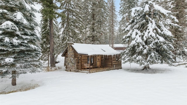 190 Black Bear Ln, Bigfork, MT 59911 - snow covered property with a chimney