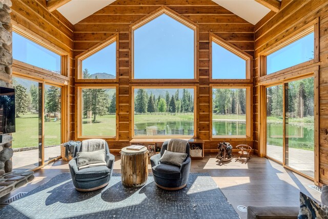 190 Black Bear Ln, Bigfork, MT 59911 - sunroom / solarium featuring high vaulted ceiling, wooden walls, and wood-type flooring