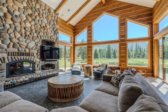 190 Black Bear Ln, Bigfork, MT 59911 - living room featuring high vaulted ceiling, a stone fireplace, wood finished floors, beam ceiling, and wood walls