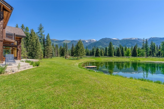 190 Black Bear Ln, Bigfork, MT 59911 - view of grassy yard featuring a water and mountain view and a view of trees