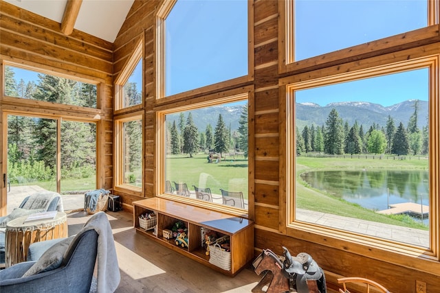 190 Black Bear Ln, Bigfork, MT 59911 - sunroom / solarium with plenty of natural light, lofted ceiling, a view of trees, and a water and mountain view