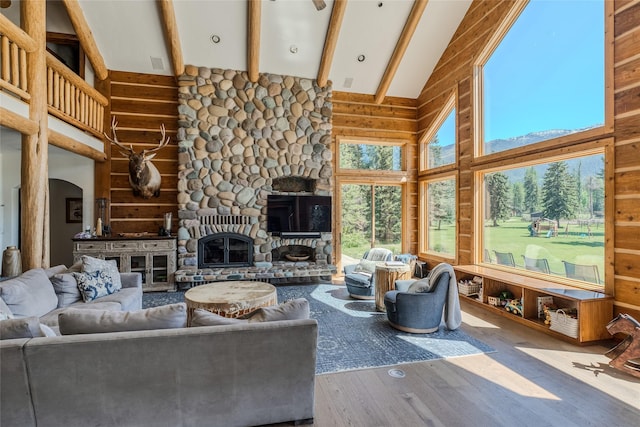 190 Black Bear Ln, Bigfork, MT 59911 - living room with high vaulted ceiling, wood finished floors, beam ceiling, arched walkways, and a fireplace