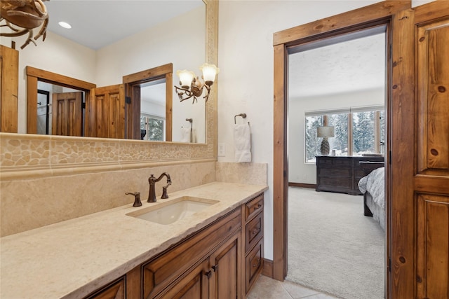 bathroom with vanity, a notable chandelier, and tile patterned floors