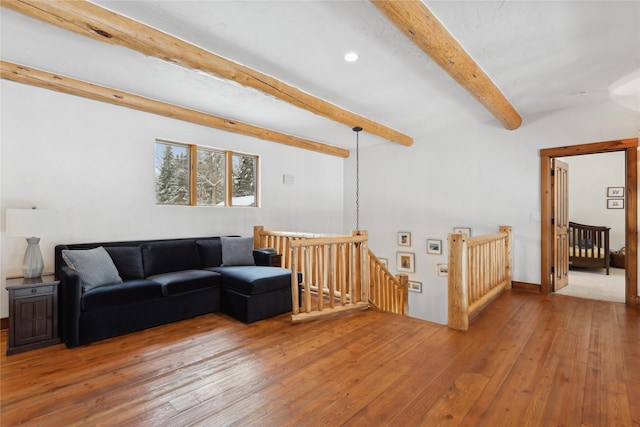 living room featuring beam ceiling and wood-type flooring