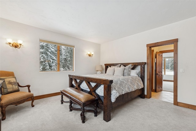 190 Black Bear Ln, Bigfork, MT 59911 - bedroom with light carpet, multiple windows, and baseboards