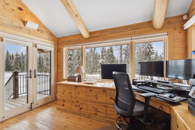 office with light hardwood / wood-style floors, vaulted ceiling with beams, french doors, and wooden walls