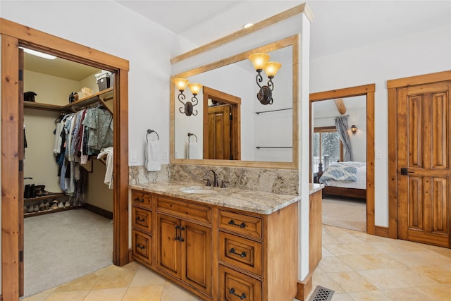 bathroom with vanity and decorative backsplash