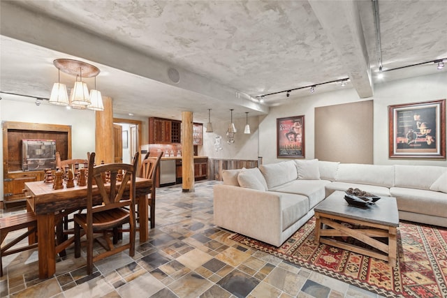 living room with a chandelier and rail lighting