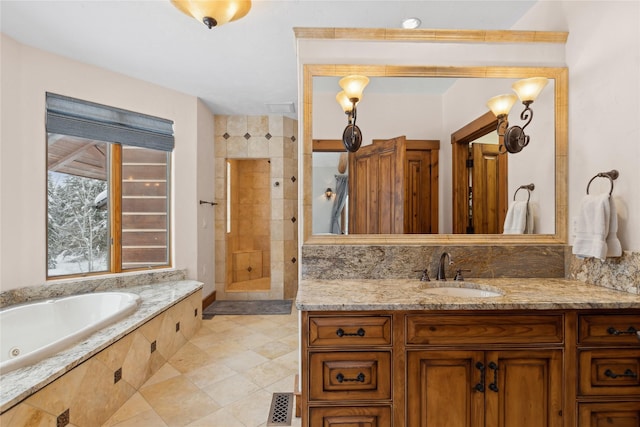 190 Black Bear Ln, Bigfork, MT 59911 - full bath featuring a jetted tub, vanity, tiled shower, and tile patterned floors