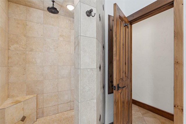 190 Black Bear Ln, Bigfork, MT 59911 - full bathroom featuring a tile shower, tile patterned floors, and baseboards