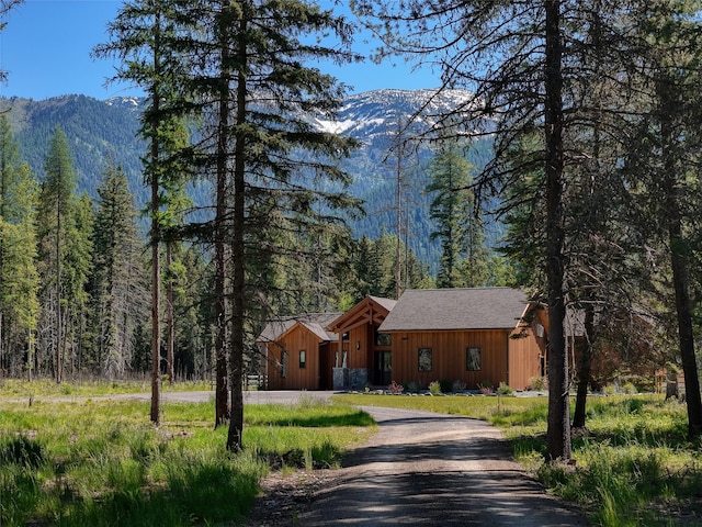 190 Black Bear Ln, Bigfork, MT 59911 - view of front facade featuring a mountain view, a wooded view, and board and batten siding