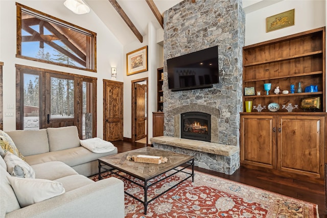 living room featuring a stone fireplace, dark wood-type flooring, built in features, high vaulted ceiling, and beamed ceiling