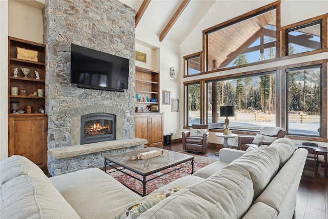 living room featuring high vaulted ceiling, a fireplace, beamed ceiling, and hardwood / wood-style floors